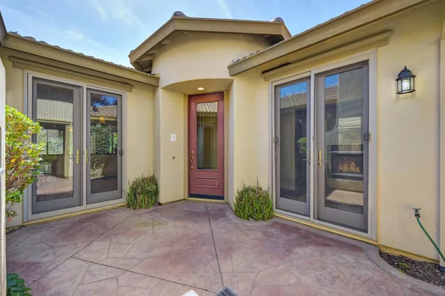 a view of a big room with chandelier fan and windows