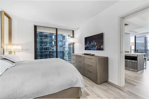 a bedroom with a bed and a flat screen television