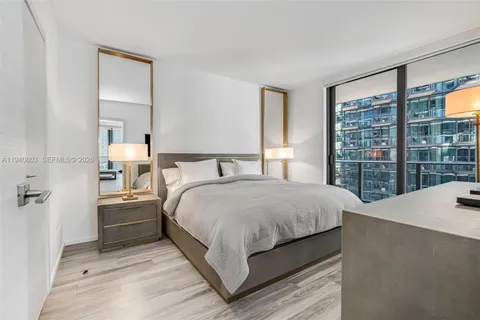 a bedroom with a large bed and a large window