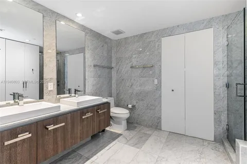 a spacious bathroom with a double vanity sink mirror and double