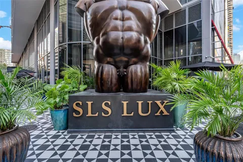 a view of a sign board with potted plants