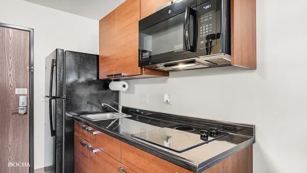 a stove top oven sitting inside of a kitchen