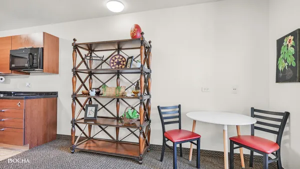 a view of a room with furniture and a flat screen tv