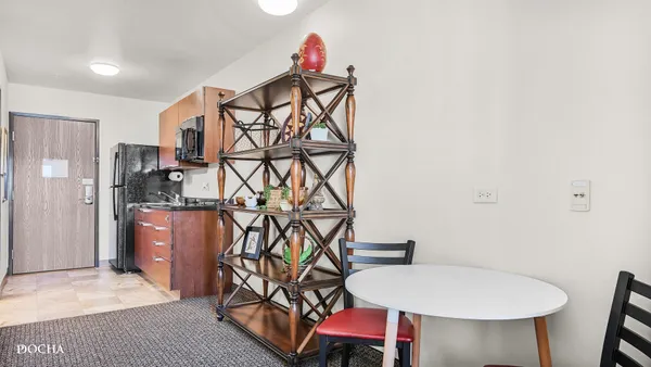 a workspace room with furniture and wooden floor