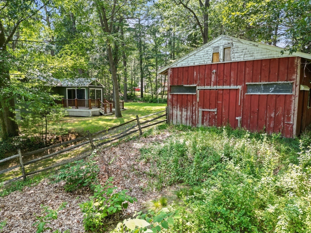 118 Echo Cove Road Hamilton, MA 01982 - Photo 30 of 40 a view of backyard with wooden fence and large trees