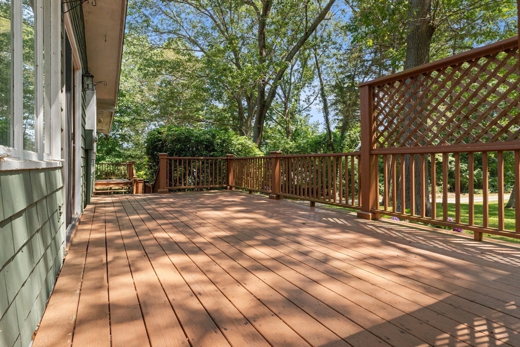 118 Echo Cove Road Hamilton, MA 01982 - Photo 31 of 40 a view of backyard with large trees and wooden fence