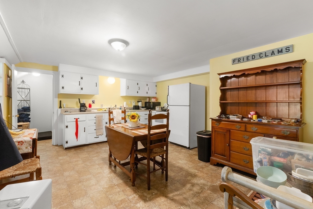 118 Echo Cove Road Hamilton, MA 01982 - Photo 38 of 40 a kitchen with a refrigerator a stove top oven a sink dishwasher and white cabinets with wooden floor