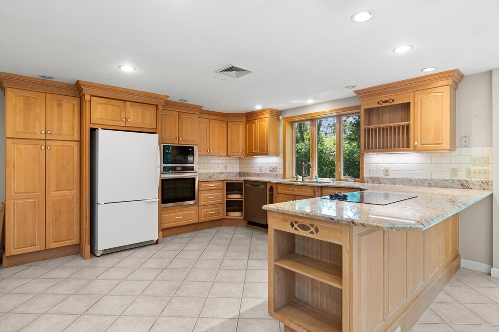 118 Echo Cove Road Hamilton, MA 01982 - Photo 5 of 40 a kitchen with a stove a sink dishwasher a refrigerator and cabinets