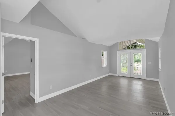 a view of an empty room with wooden floor