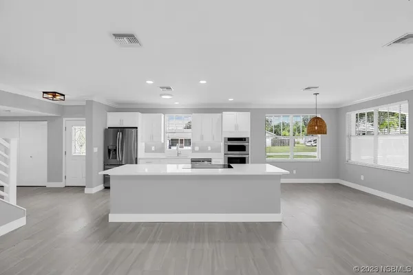 a kitchen with a sink stainless steel appliances and cabinets