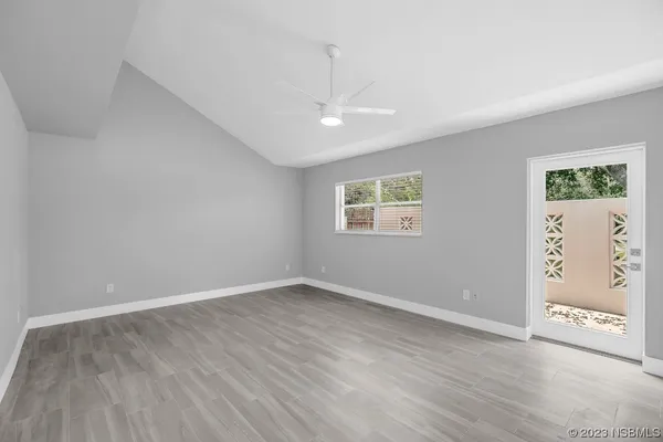 a view of an empty room with wooden floor