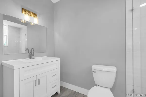 a view of a room with wooden floor and window