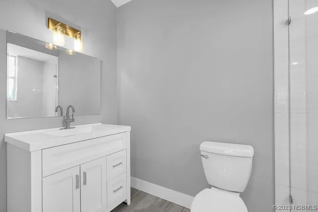 a view of a room with wooden floor and window