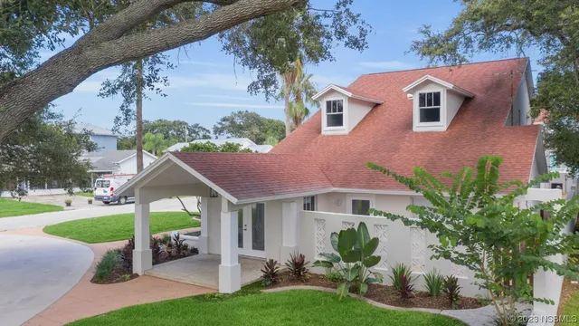 a front view of a house with garden