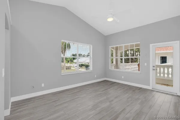 a white house that has wooden floor in front of it