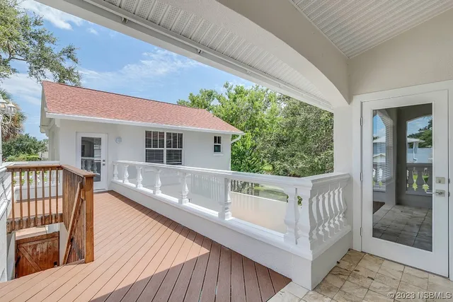 a view of a kitchen with wooden floor and stainless steel appliances
