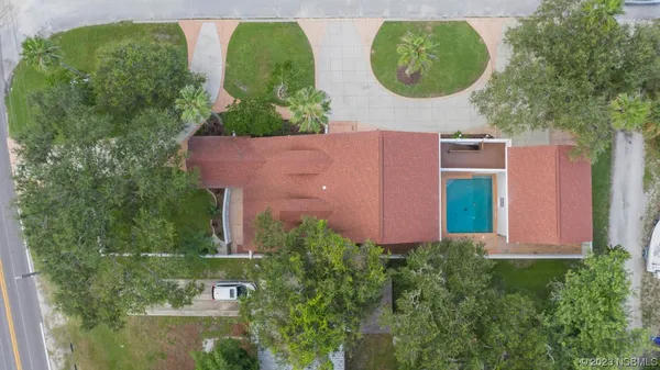 a aerial view of a house with a yard and a fountain