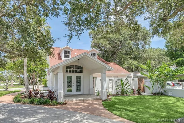 a front view of a house with a garden