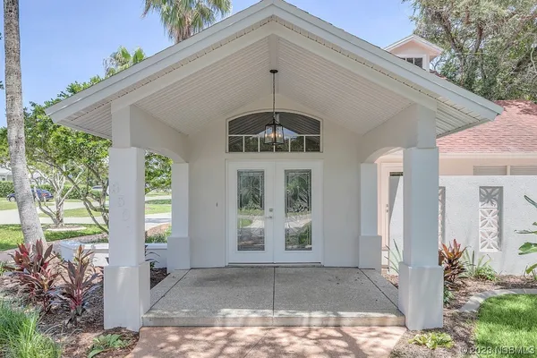 a view of a hallway with wooden floor and windows