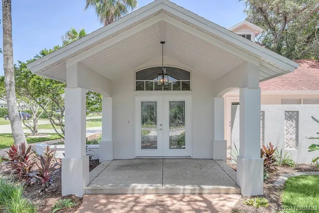 a view of a hallway with wooden floor and windows