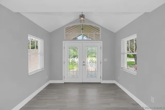 wooden floor in a hall with an empty room