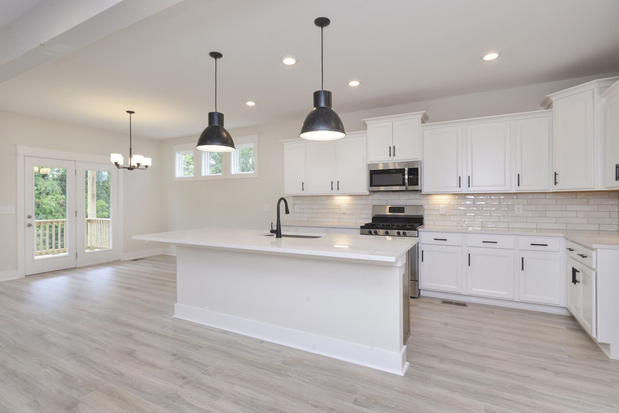 79 Remington Road Lebanon, TN 37090 - Photo 1 of 38 a large kitchen with granite countertop a stove a sink a center island and wooden floor