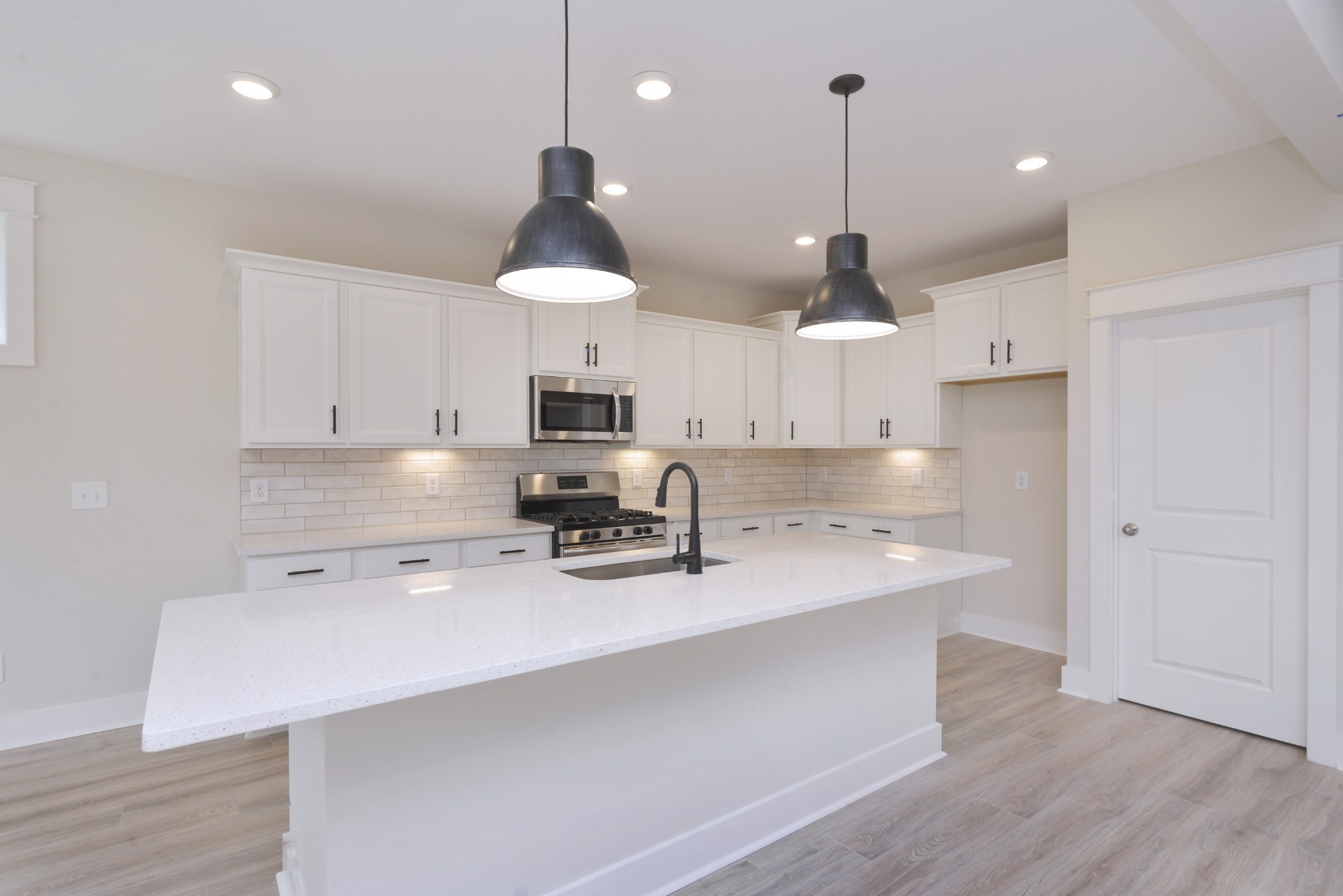 79 Remington Road Lebanon, TN 37090 - Photo 15 of 38 a kitchen with stainless steel appliances a stove a sink a center island and a refrigerator