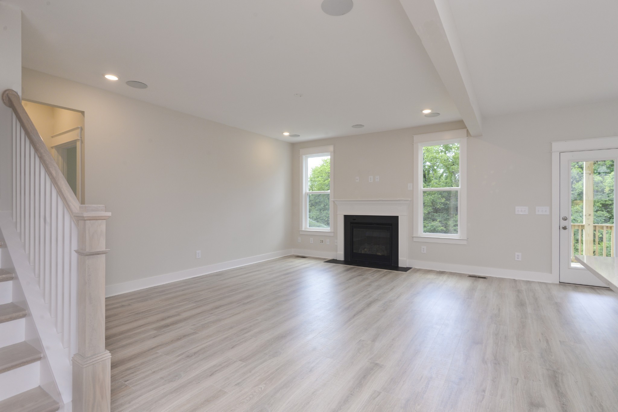 79 Remington Road Lebanon, TN 37090 - Photo 18 of 38 an empty room with wooden floor fireplace and windows