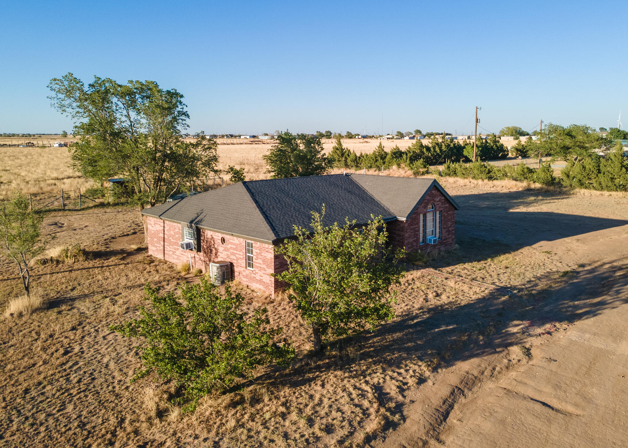 6917 Highway 114 Lubbock, TX 79407 - Photo 37 of 45 an aerial view of a house with a yard and lake view
