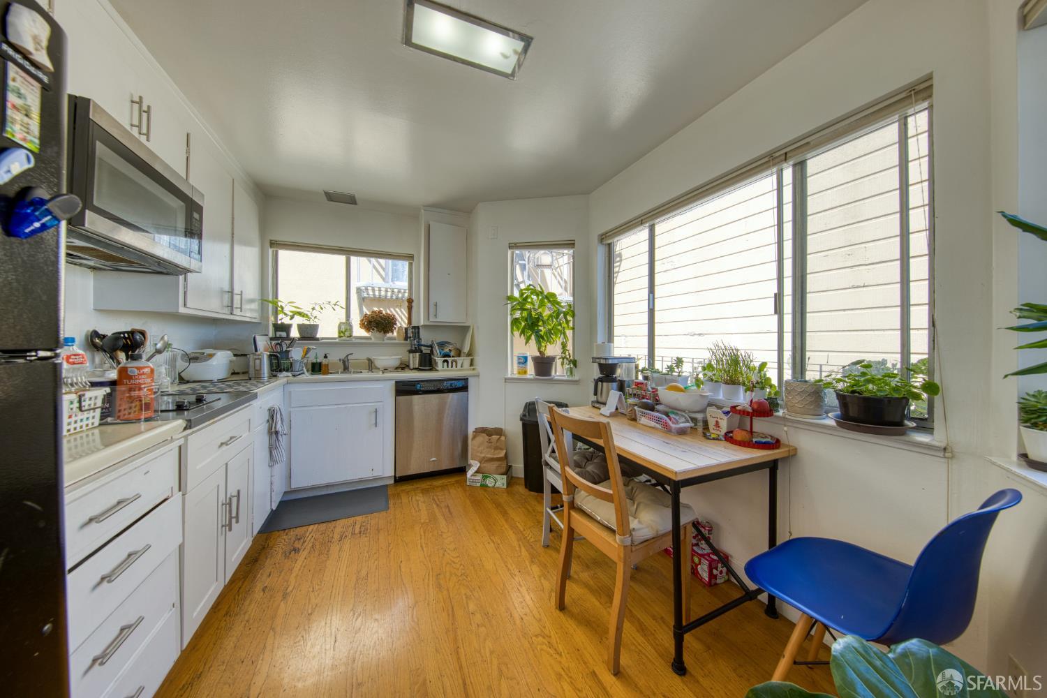 40 Irving Street San Francisco, CA 94122 - Photo 2 of 13 a kitchen with a table chairs stove and cabinets
