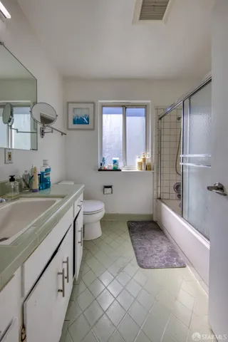 a spacious bathroom with a bathtub shower sink and mirror