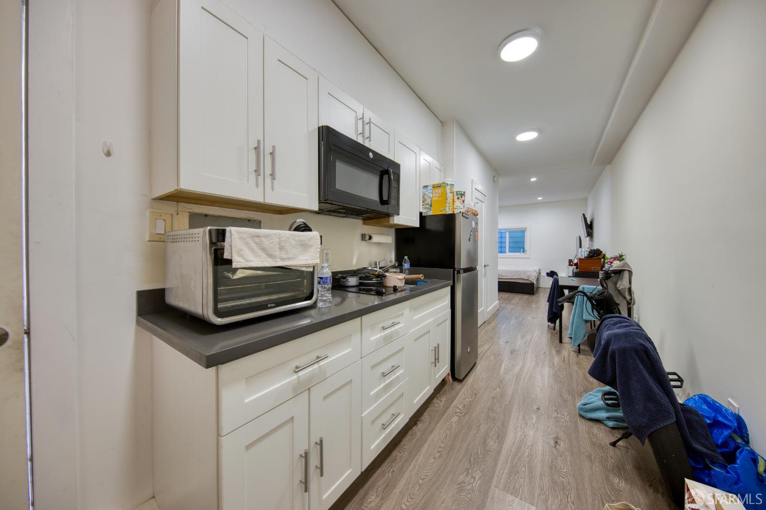 40 Irving Street San Francisco, CA 94122 - Photo 6 of 13 a kitchen with stainless steel appliances white cabinets sink and a granite counter top