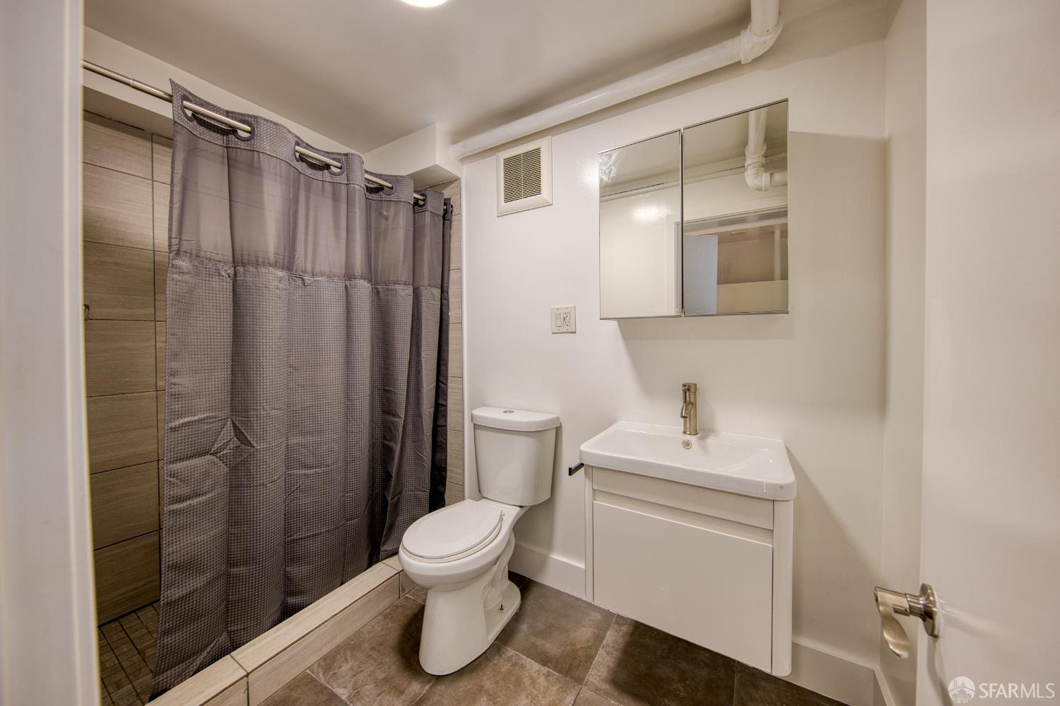 40 Irving Street San Francisco, CA 94122 - Photo 8 of 13 a white toilet sitting next to a bathroom sink