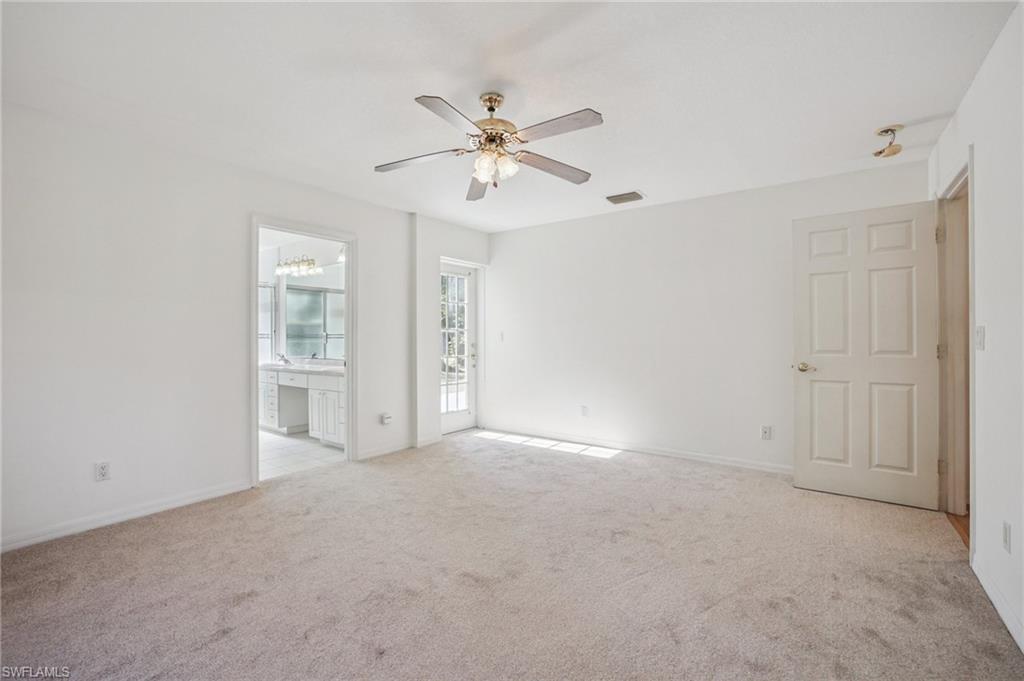 5348 Cypress Lane Naples, FL 34113 - Photo 13 of 28 a view of empty room with window and ceiling fan