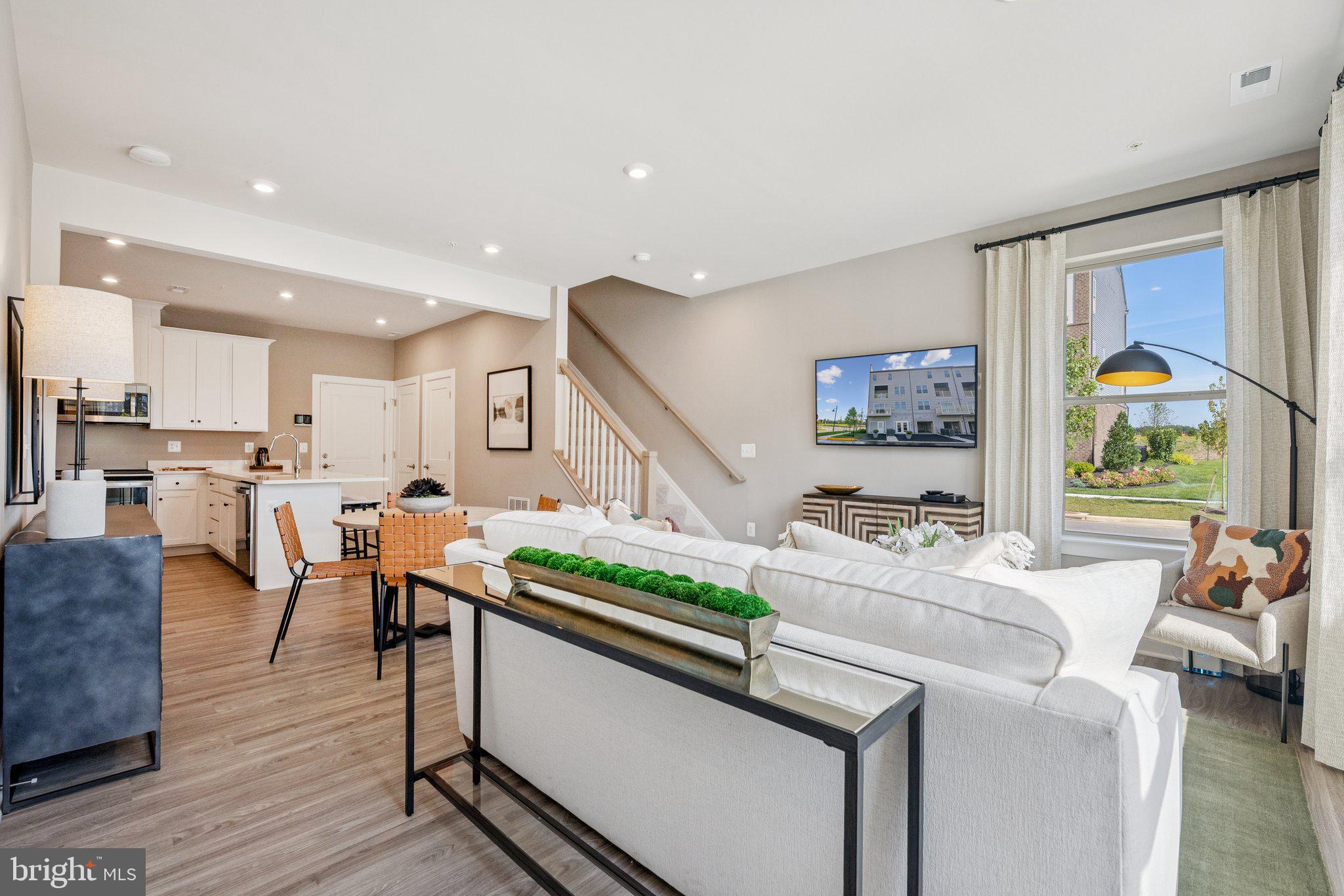 6715 Belcrest Road Hyattsville, MD 20782 - Photo 5 of 28 a living room with stainless steel appliances furniture a rug and a kitchen view