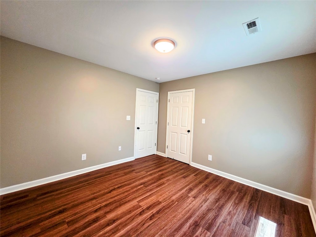 509 Elrod Road Piedmont, SC 29673 - Photo 18 of 28 Rich hardwood-style flooring extends across this tranquil room, offering a warm and inviting atmosphere.