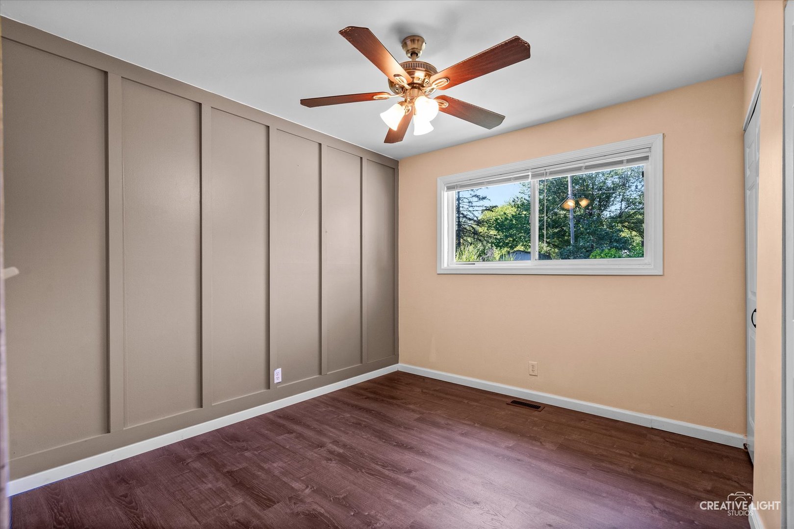 54 Sierra Road Montgomery, IL 60538 - Photo 12 of 17 an empty room with wooden floor chandelier fan and windows