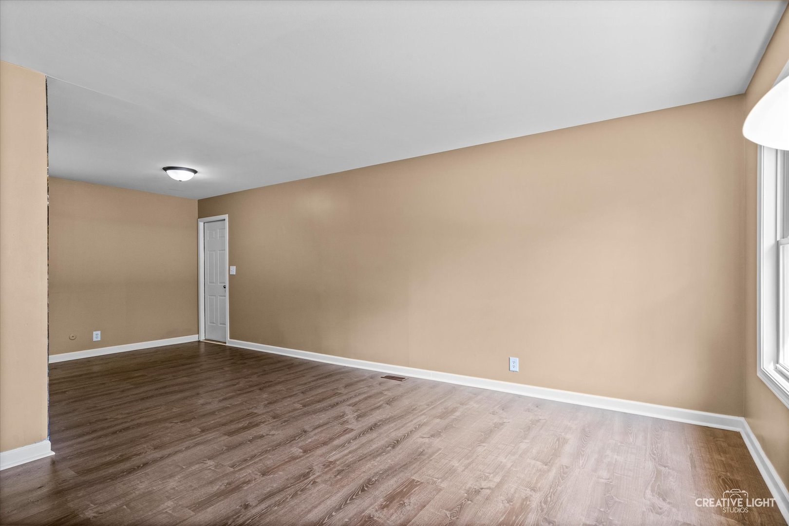 54 Sierra Road Montgomery, IL 60538 - Photo 14 of 17 a view of an empty room with wooden floor and a window