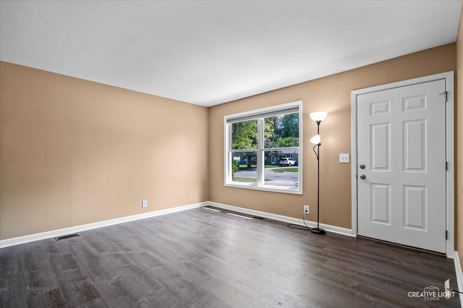 54 Sierra Road Montgomery, IL 60538 - Photo 3 of 17 an empty room with wooden floor and windows
