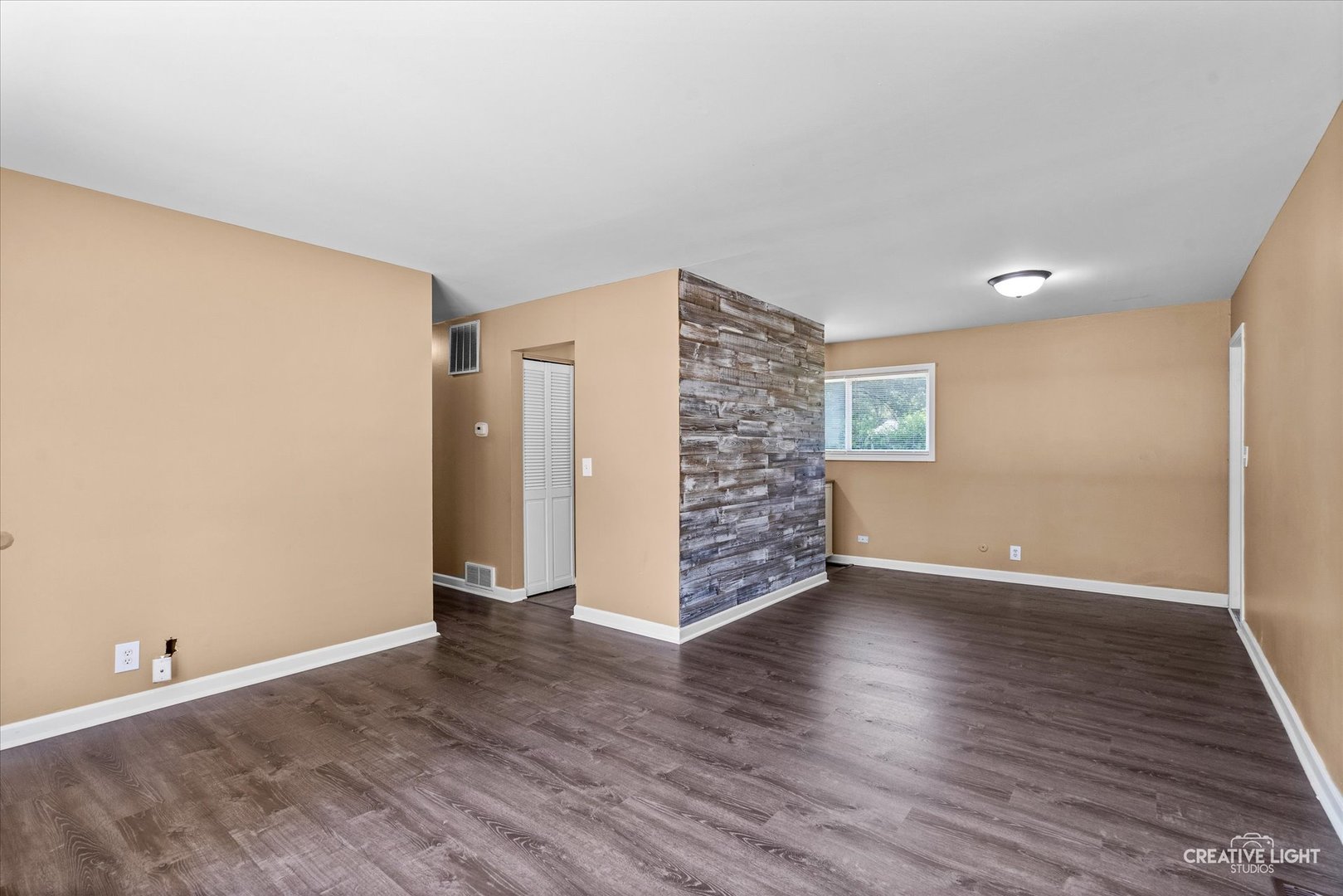 54 Sierra Road Montgomery, IL 60538 - Photo 4 of 17 a view of an empty room with wooden floor and a window