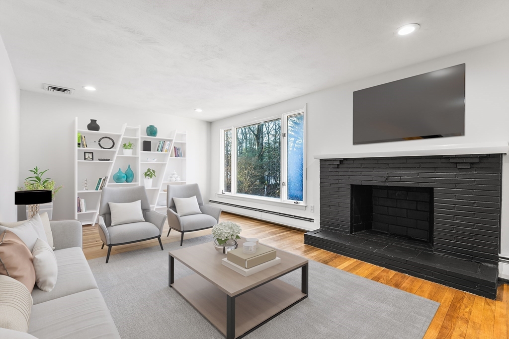 7 Pinewood Road Peabody, MA 01960 - Photo 4 of 11 a living room with furniture a flat screen tv and a fireplace