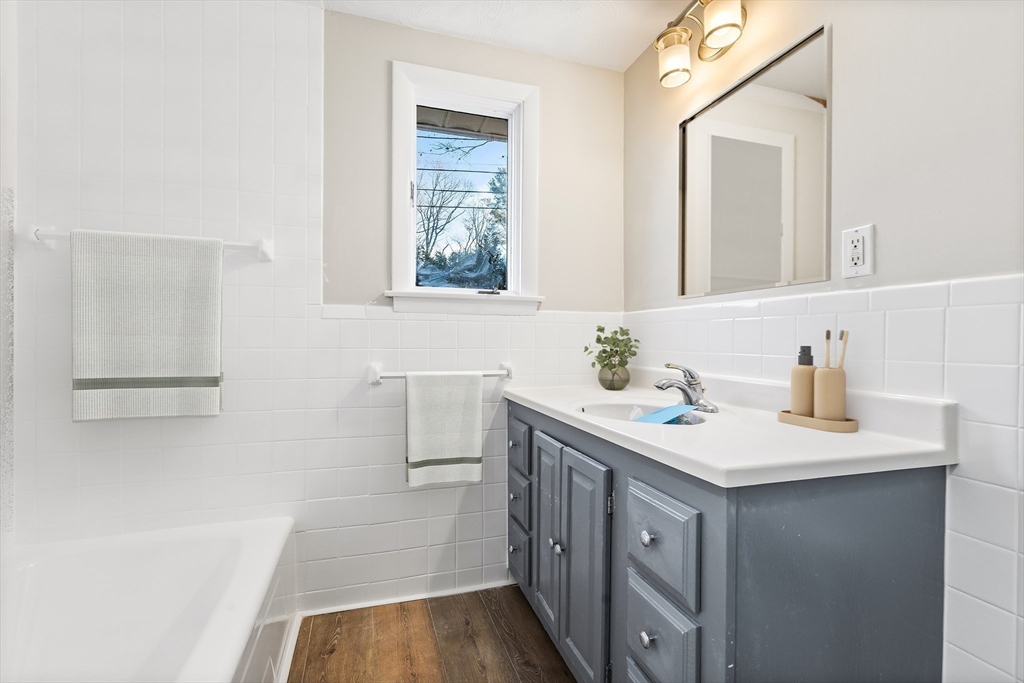 7 Pinewood Road Peabody, MA 01960 - Photo 8 of 11 a bathroom with a sink a vanity and a mirror