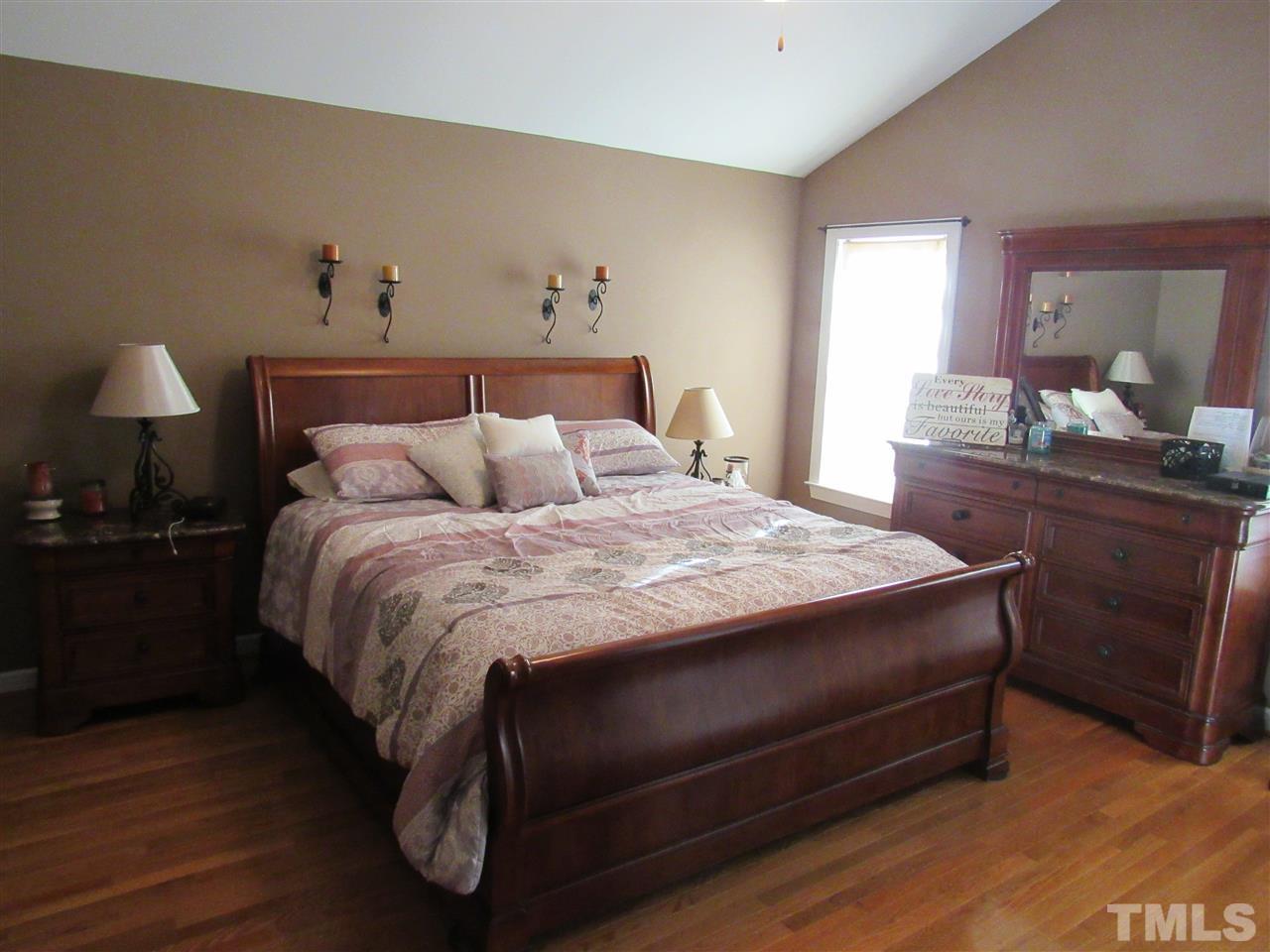 279 Steve Ridge Willow Spring, NC 27592 - Photo 12 of 25 a bedroom with a bed and a lamp