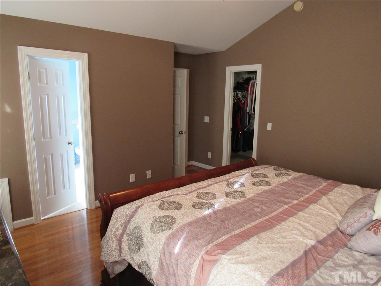 279 Steve Ridge Willow Spring, NC 27592 - Photo 13 of 25 a bedroom with a bed and wooden floor