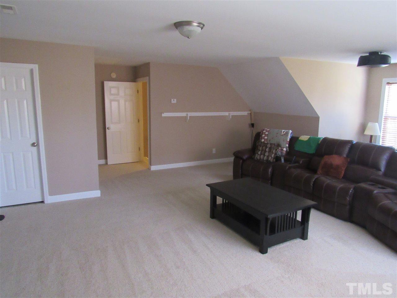279 Steve Ridge Willow Spring, NC 27592 - Photo 16 of 25 a living room with furniture and a potted plant