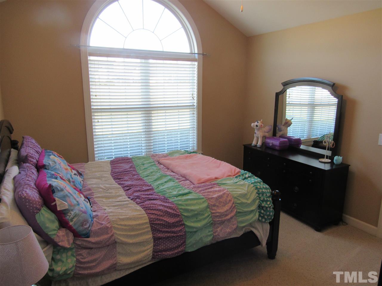 279 Steve Ridge Willow Spring, NC 27592 - Photo 19 of 25 a bedroom with a bed and a mirror