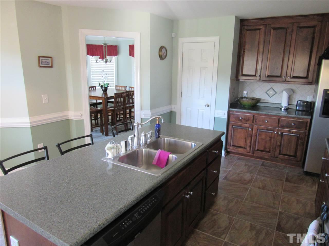279 Steve Ridge Willow Spring, NC 27592 - Photo 9 of 25 a kitchen with granite countertop a sink and cabinets