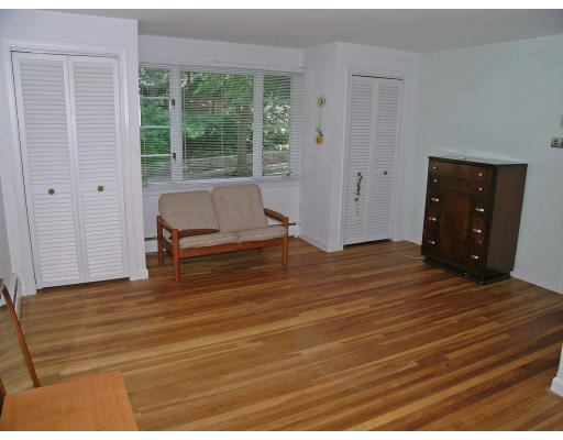 75 Wolcott Road Brookline, MA 02467 - Photo 11 of 16 a bedroom with a bed and wooden floor