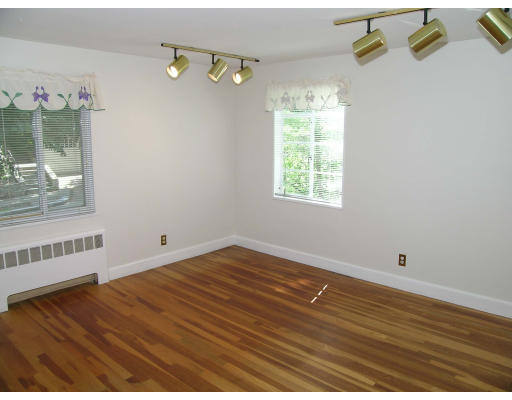 75 Wolcott Road Brookline, MA 02467 - Photo 13 of 16 an empty room with wooden floor and windows