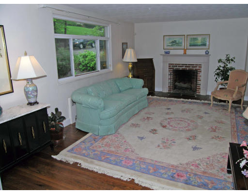 75 Wolcott Road Brookline, MA 02467 - Photo 7 of 16 a living room with furniture and a fireplace